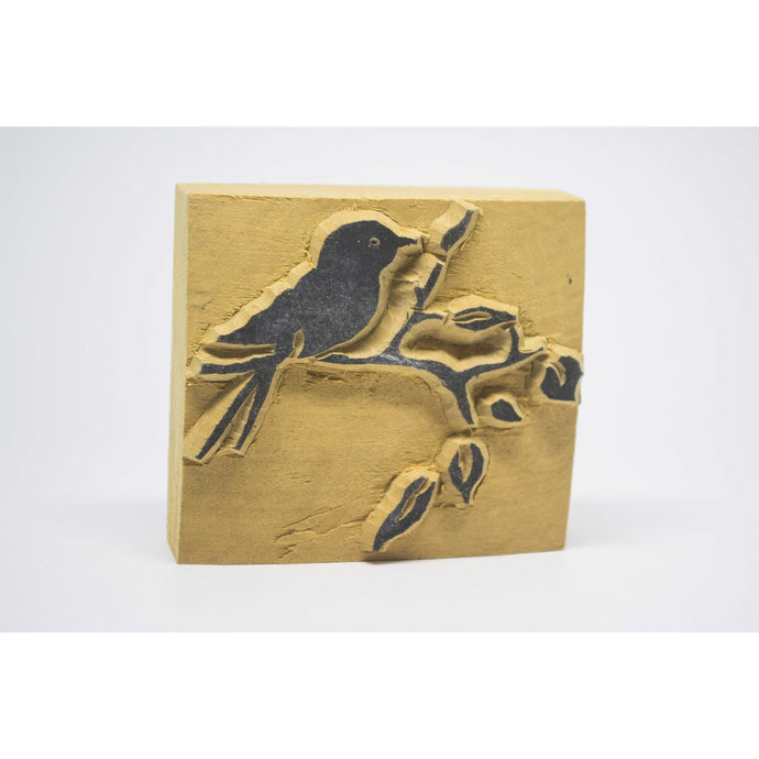 Wooden stamp bird on a branch